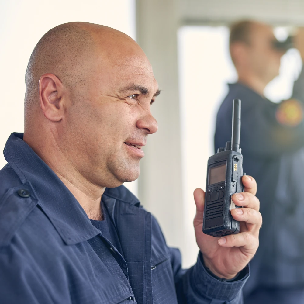 smiling-handsome-worker-holding-walkie-talkie